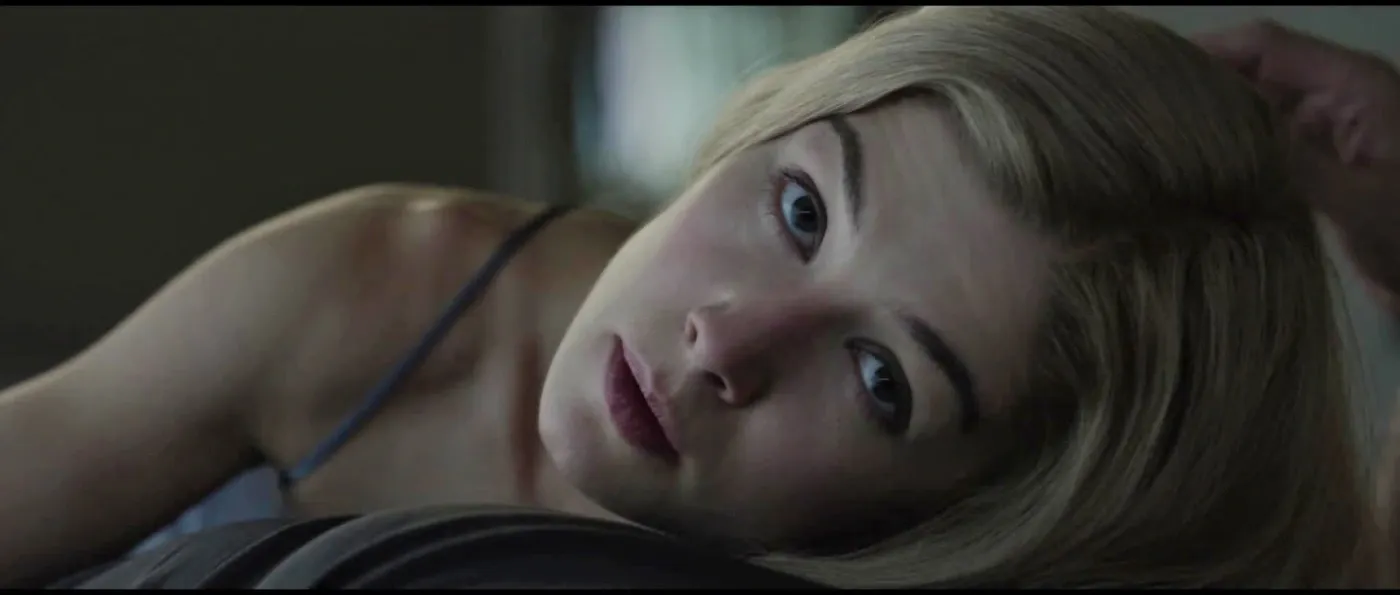 Amy Elliot Dunne (Rosamund Pike) looks up at her husband laying next to her in Gone Girl