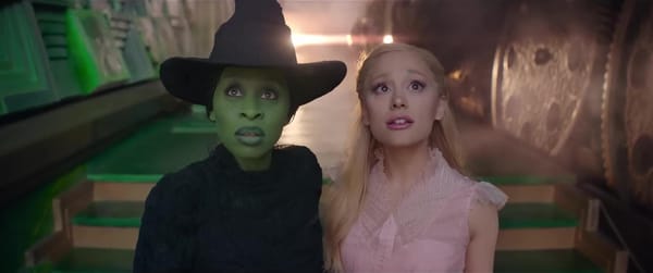 Elphaba (Cynthia Erivo) and Galinda (Ariana Grande-Butera) stand in the chamber of the Wizard of Oz in Wicked (2024)