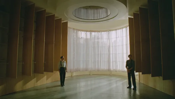 László Tóth (Adrian Brody) and his cousin Attila (Alessandro Nivola) look at their finished library remodel in The Brutalist