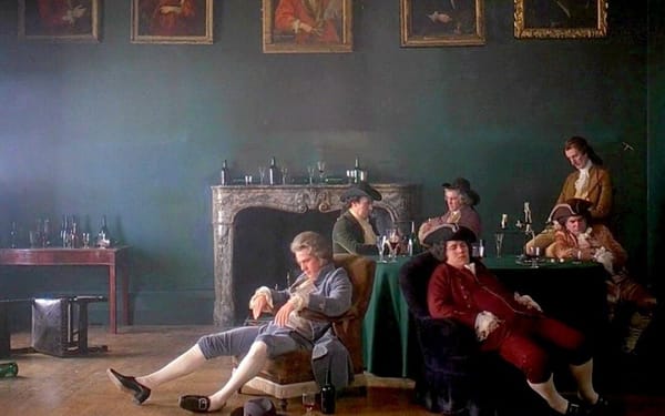 Barry Lyndon (Ryan O'Neal) sits passed out center screen as his companions sitting at a table in Barry Lyndon